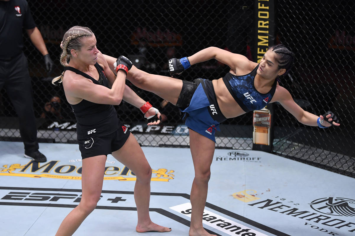 (R-L) Cynthia Calvillo kicks Katlyn Chookagian in their women's flyweight bout during the UFC 2 ...
