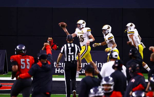 Wyoming Cowboys quarterback Levi Williams (15) celebrates a touchdown against the UNLV Rebels d ...