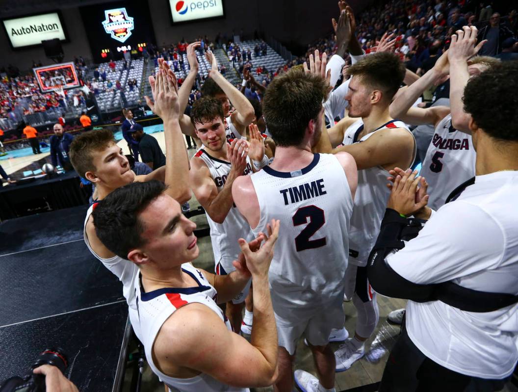 Gonzaga players celebrate after defeating St. Mary's to win the West Coast Conference tournamen ...