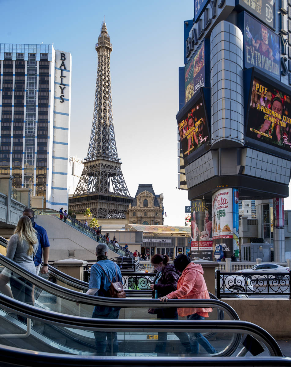 Pedestrians take the escalators adjacent to The Cromwell and BallyÕs along the Las Vegas S ...