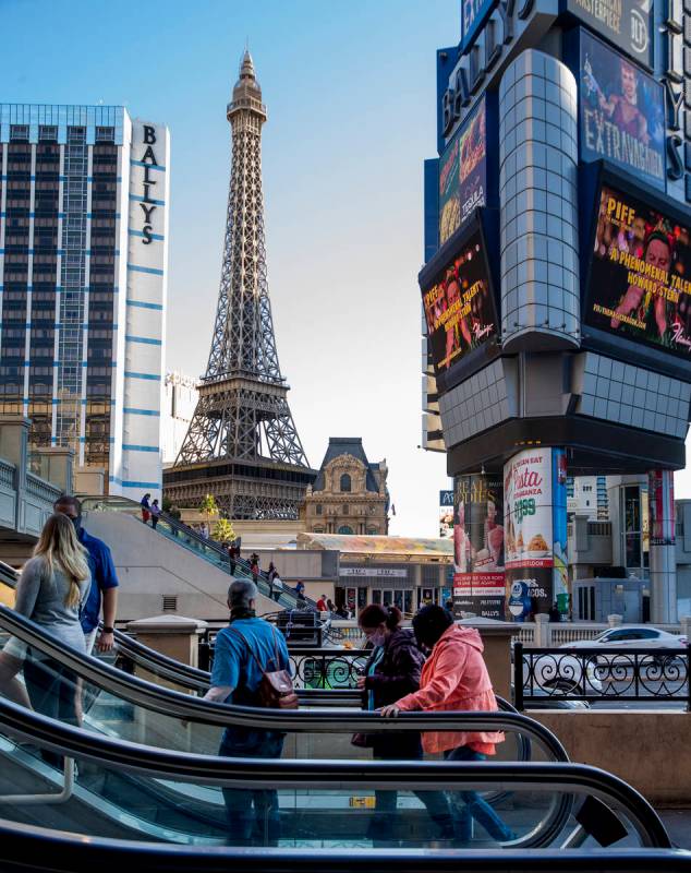 Pedestrians take the escalators adjacent to The Cromwell and BallyÕs along the Las Vegas S ...