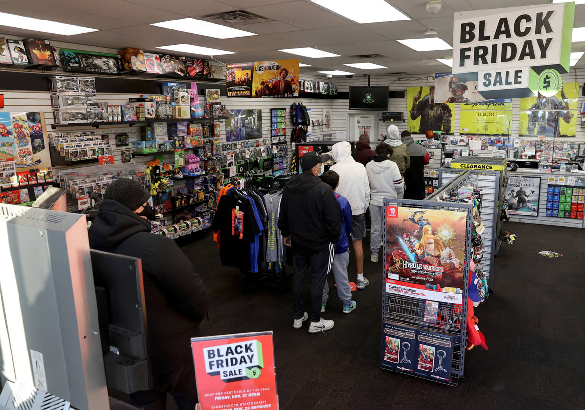Shoppers line up for Black Friday deals at GameStop on East Tropicana Avenue at McLeod Drive in ...