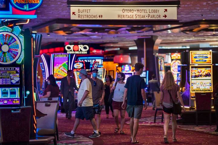 Guests wander about a main walkway in the casino as the Mirage reopens following a COVID-19 shu ...