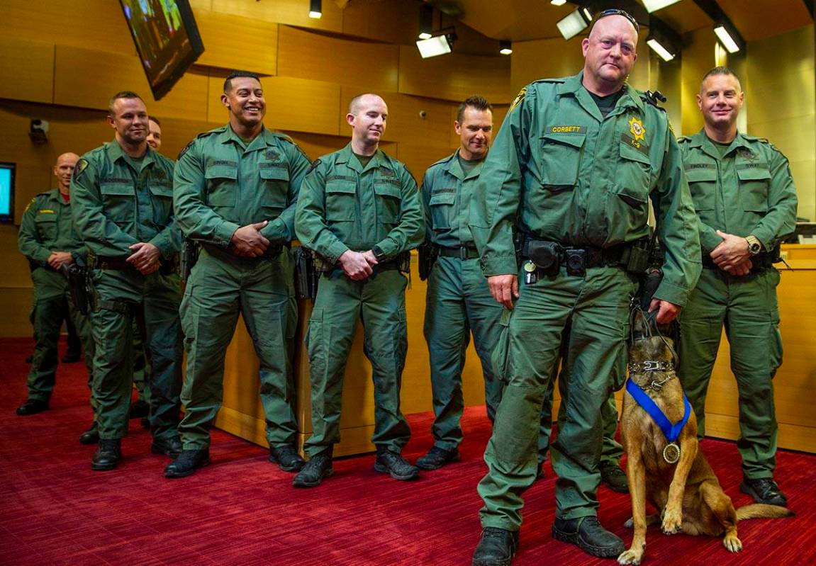 Las Vegas police K-9 officer Jeff Corbett with his dog Hunter are flanked by other officers whi ...
