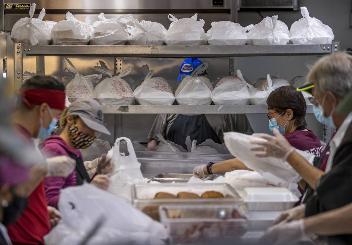 Volunteers prep several hundred Thanksgiving meals at the Las Vegas Rescue Mission with food do ...