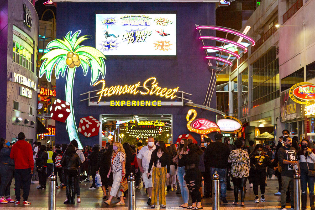 People walk along the Fremont Street Experience in downtown Las Vegas on Saturday, Nov. 21, 202 ...