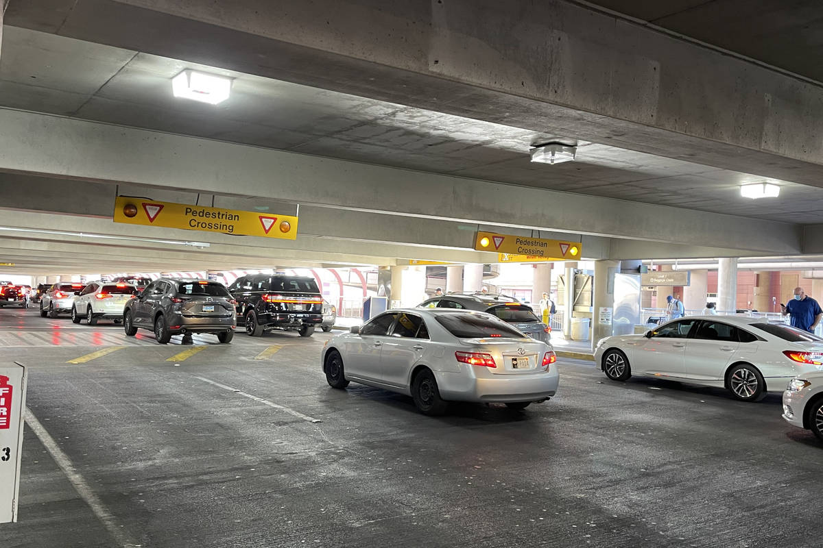 Vehicles line up to awaiting travelers at McCarran International Airport's passenger pick up ar ...