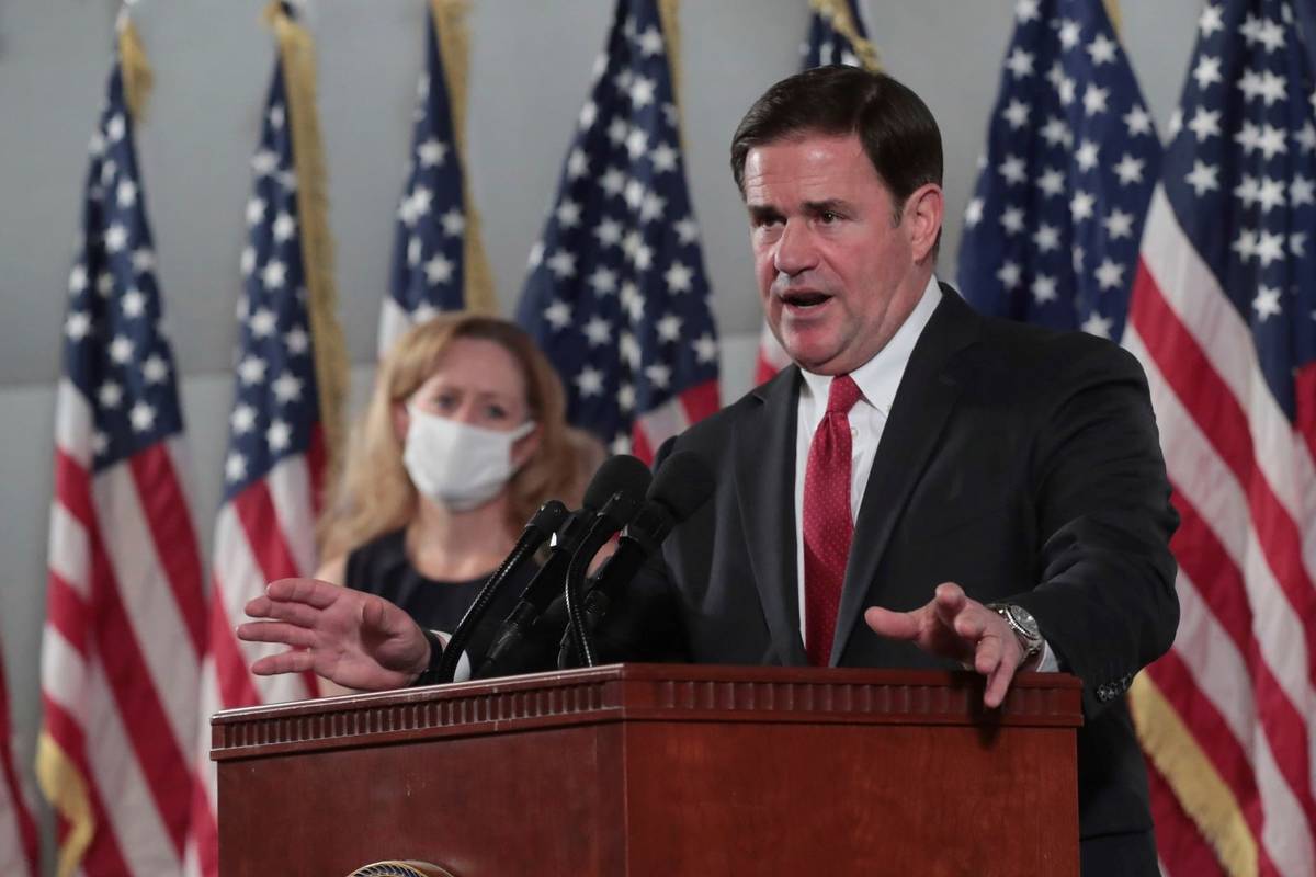 Arizona Gov. Doug Ducey addresses the media on COVID-19 during a news conference in Phoenix in ...
