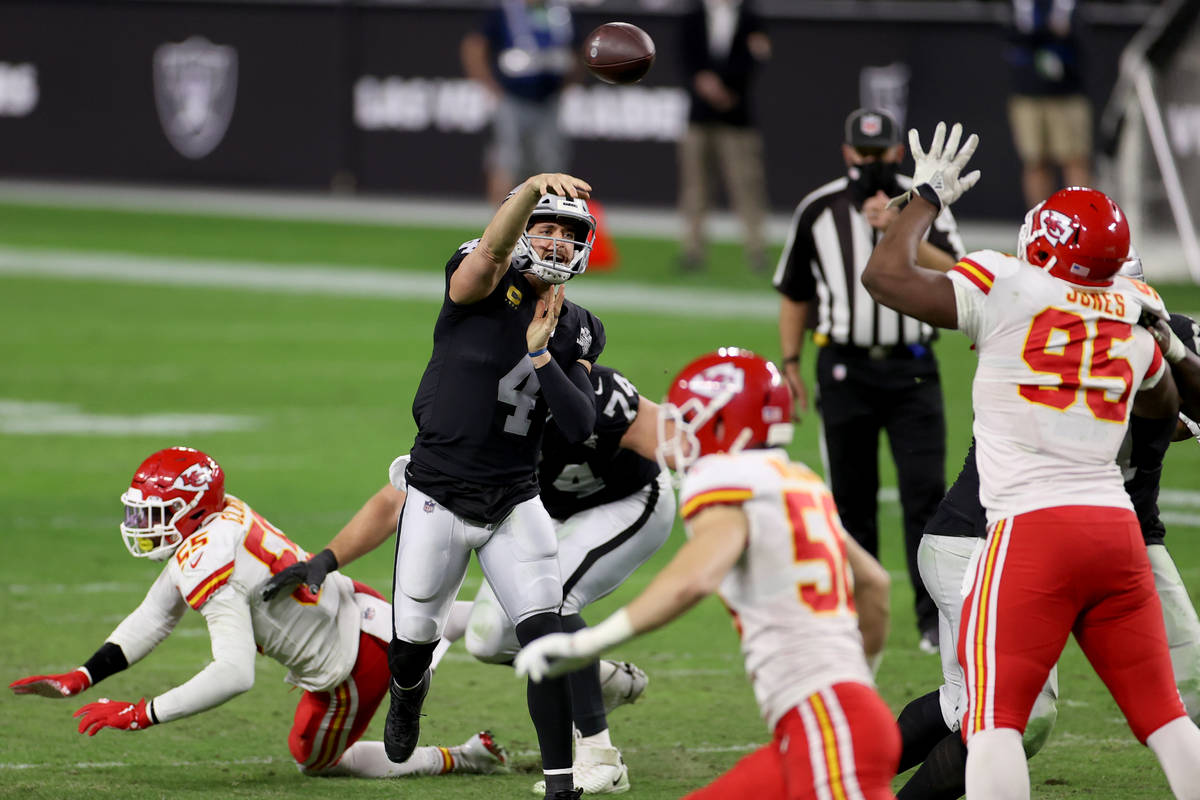 Las Vegas Raiders quarterback Derek Carr (4) throws over Kansas City Chiefs defensive tackle Ch ...