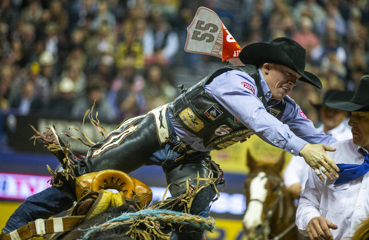 Jacobs Crawley of Boerne, Texas, hops off of Stampede Warrior in Saddle Bronc Riding during the ...