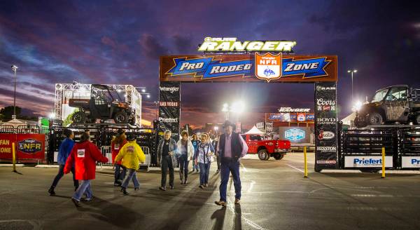 Attendees walk about the Pro Rodeo Zone during the tenth go round of the Wrangler National Fina ...