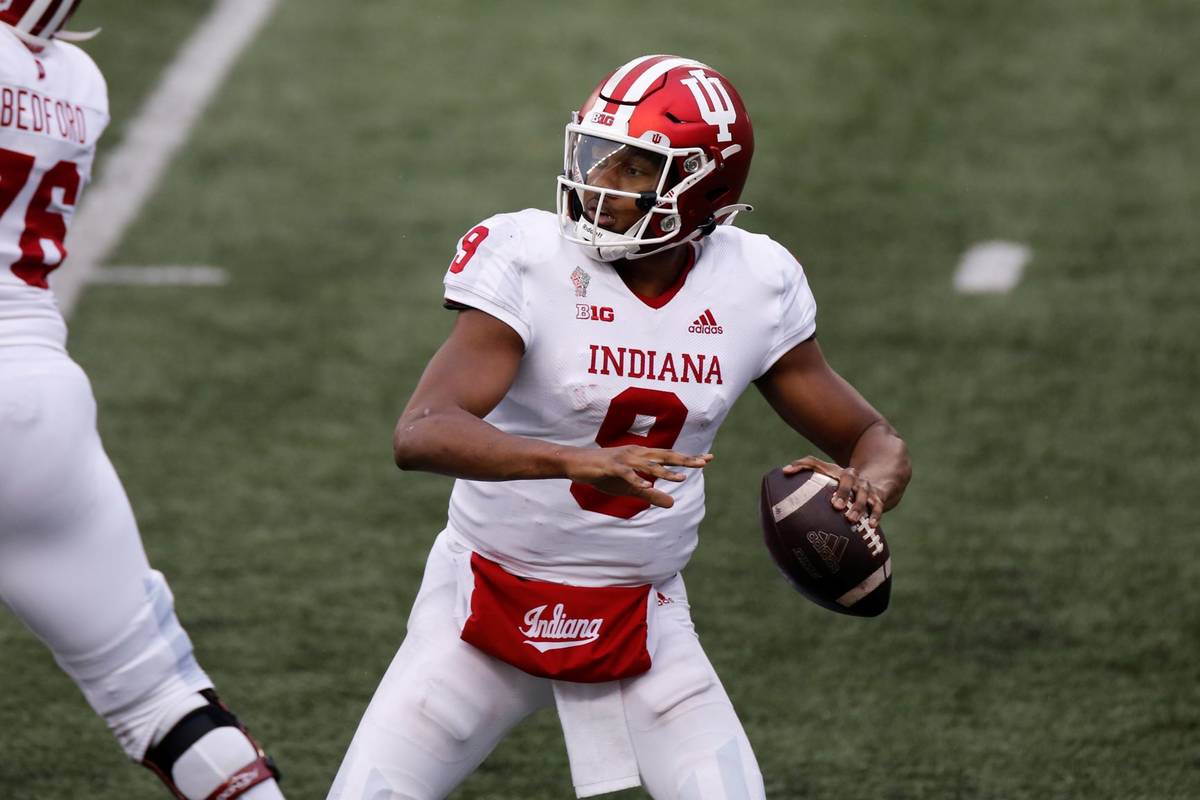 Indiana quarterback Michael Penix plays against Ohio State and during an NCAA college football ...