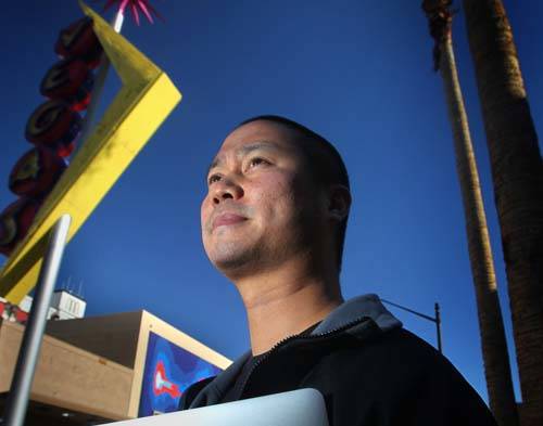 Tony Hsieh, CEO of online clothing retailer Zappos.com, stands near a Vegas neon sign in downto ...