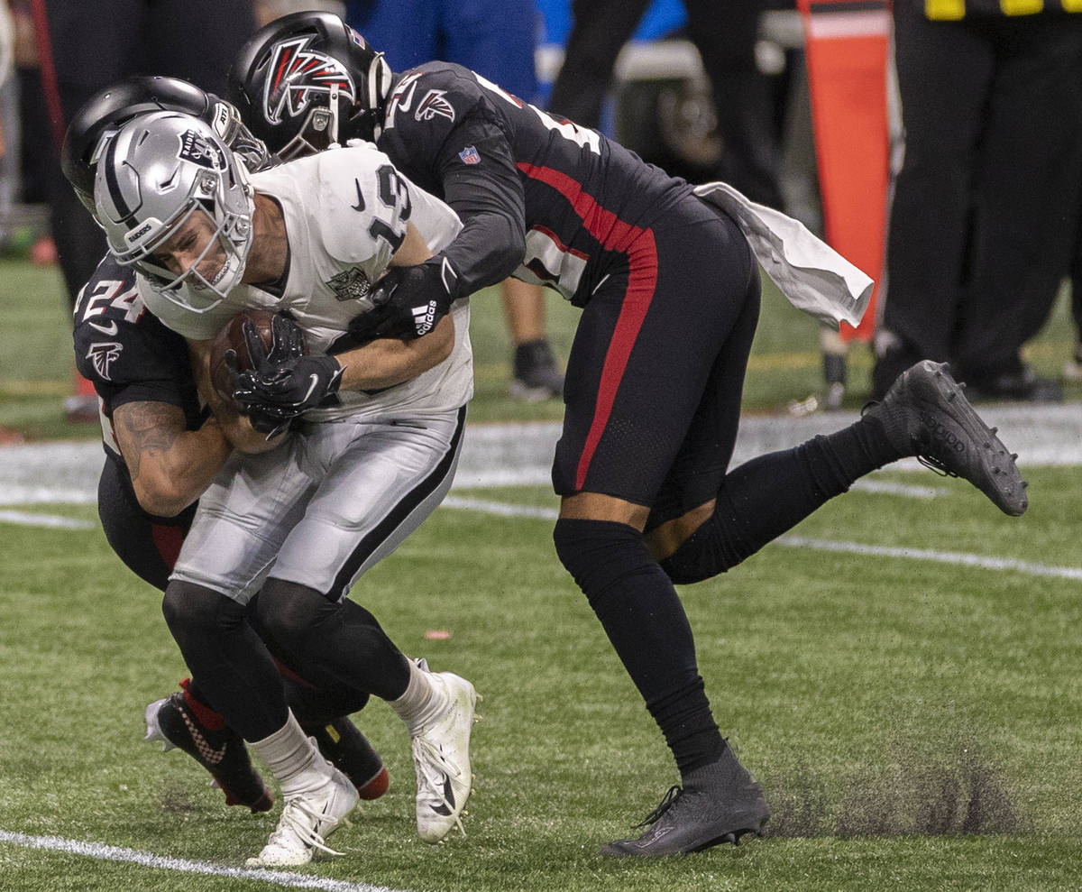 Las Vegas Raiders wide receiver Hunter Renfrow (13) is tackled by Atlanta Falcons cornerback A. ...