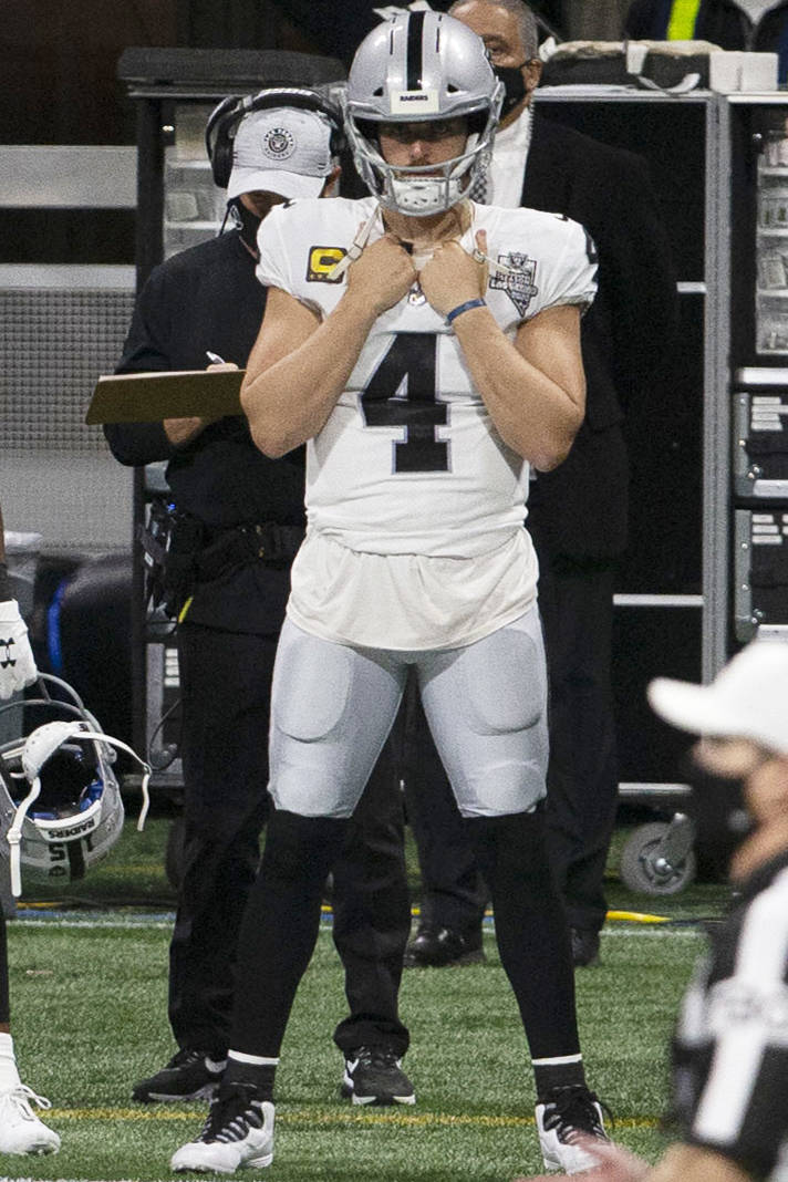 Las Vegas Raiders quarterback Derek Carr (4) watches the team play from the sideline during the ...