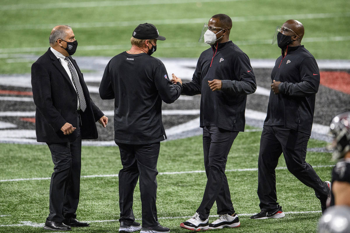 Atlanta Falcons interim head coach Raheem Morris and Las Vegas Raiders head coach Jon Gruden sh ...