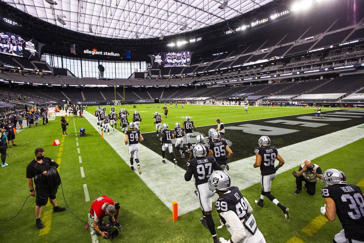 Las Vegas Raiders players run on to the field for the start of their home opening NFL game agai ...