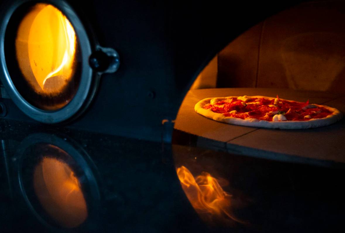 Pizza bakes in a wood-fired rotary oven on the Signora Pizza truck. (Ellen Schmidt/Las Vegas Re ...