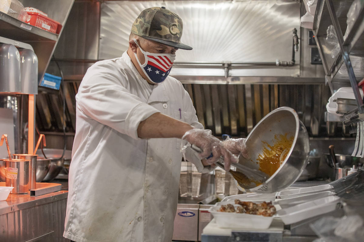 Line cook Frank Lindsey works on an order on the YourPanadas empanada truck (Elizabeth Page Bru ...