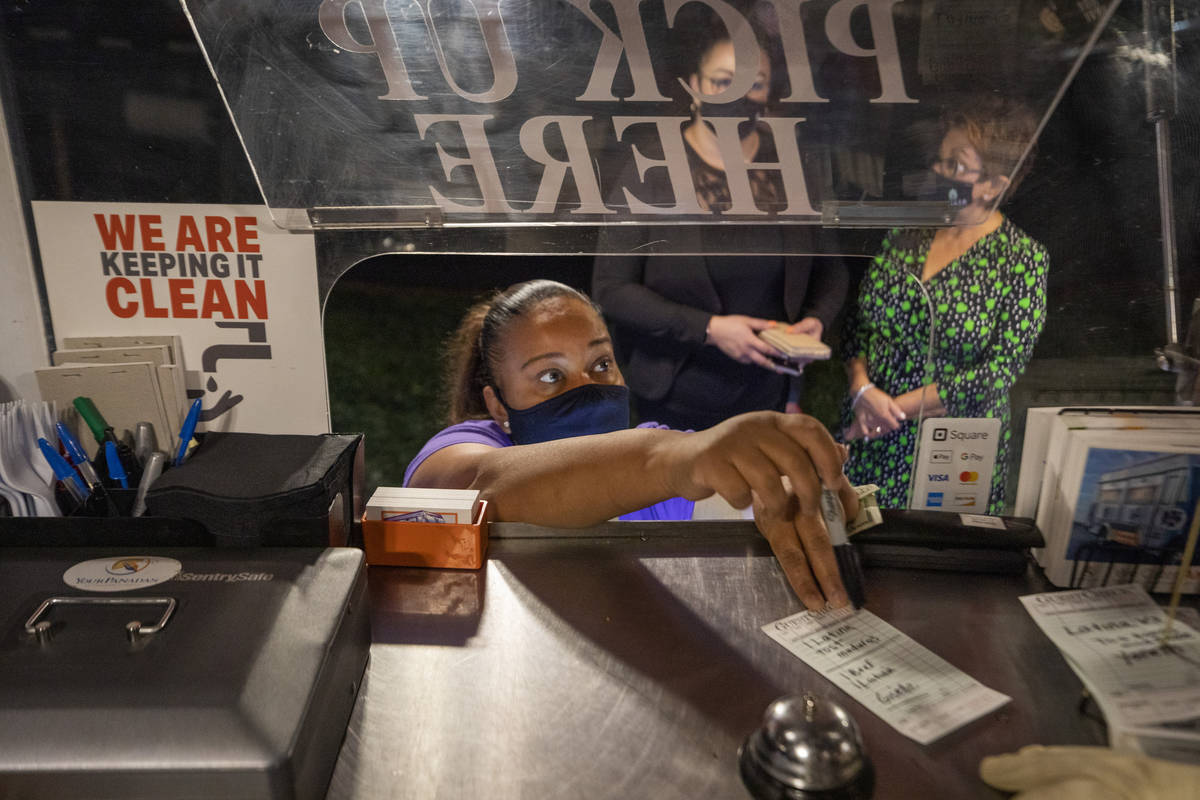 Owner Jinelle Batista places a customer's order as YourPanadas empanada truck pays a visit to A ...