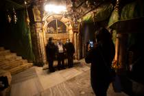 Christian take photos inside the Grotto of the Church of the Nativity, traditionally believed t ...
