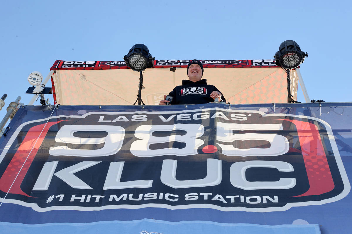 Chet Buchanan of KLUC-FM talks to volunteers atop a 30-foot scaffolding during his toy drive in ...