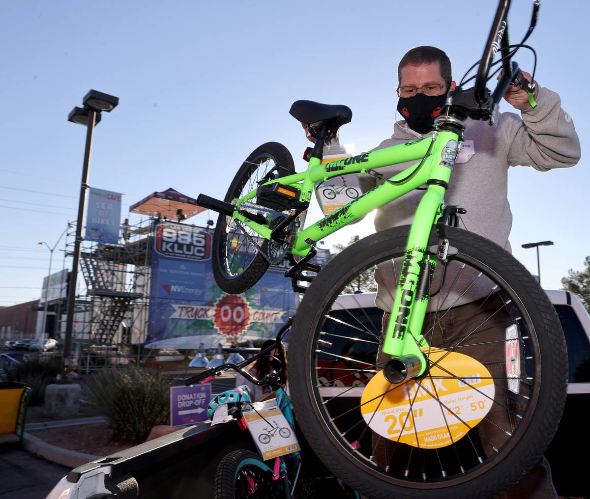 Volunteer Matt Rose loads a donated bike during the Chet Buchanan KLUC-FM toy drive in the NV E ...