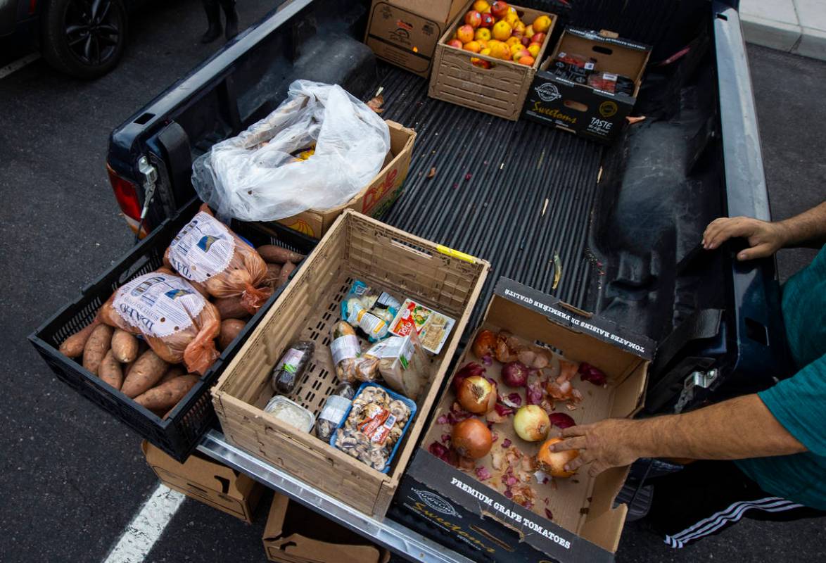 People in need get donated food from Amber Stevenson at a shopping center in Las Vegas on Wedne ...