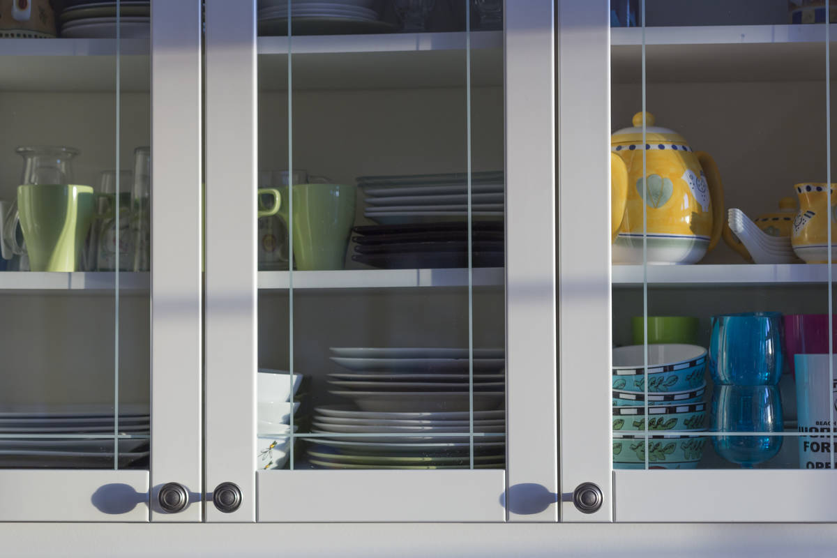 The placement of dishes and glassware in kitchen cabinets should be within reach. (Getty Images)