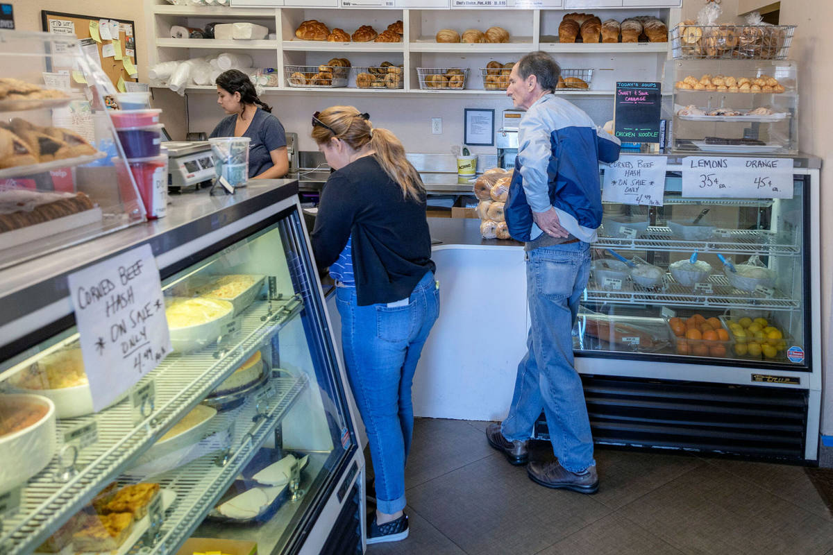 In this April 3, 2020, file photo, customers of Weiss Deli and Bakery wait to place a takeout o ...
