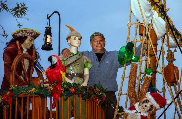 Juan Torres stands atop the pirate ship he built for his wife Maria Acosta as part of a holiday ...