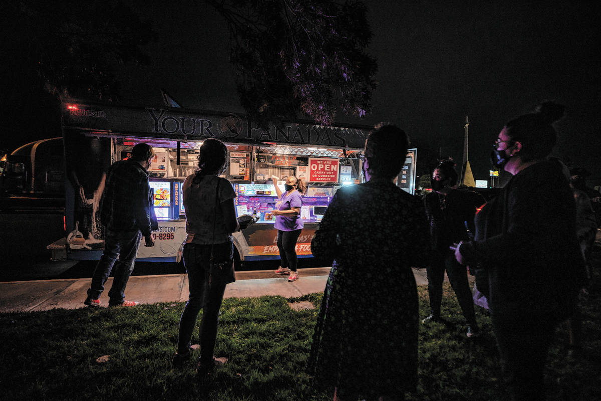 Owner Jinelle Batista, center, calls out an order from YourPandas empanada truck, at Aviata Apa ...