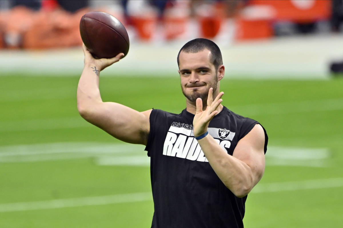 Las Vegas Raiders quarterback Derek Carr (4) warms before an NFL football game, Sunday against ...