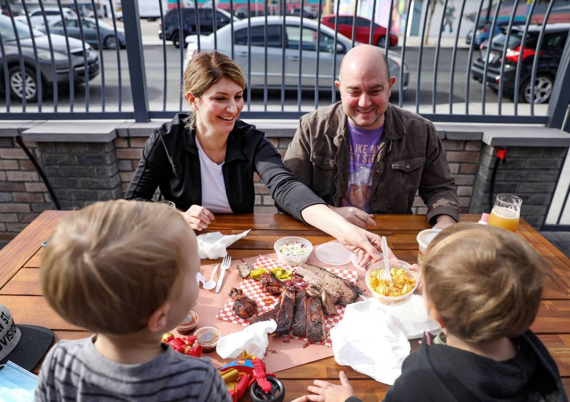 Amanda Hall, left, eats lunch with her husband Justin Hall, right, and their children Kingsley ...