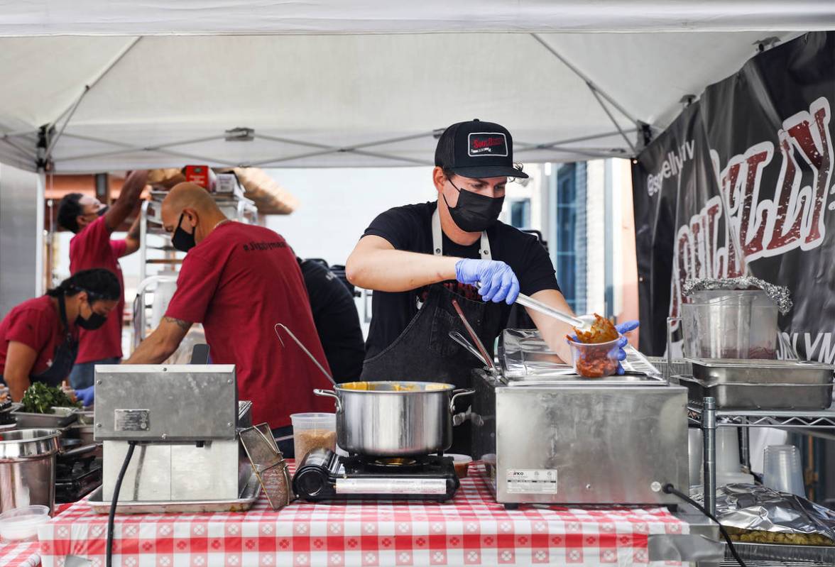 Cook Phil Hay prepares Texas ranch beans for an order at the SoulBelly BBQ pop-up in the Arts D ...