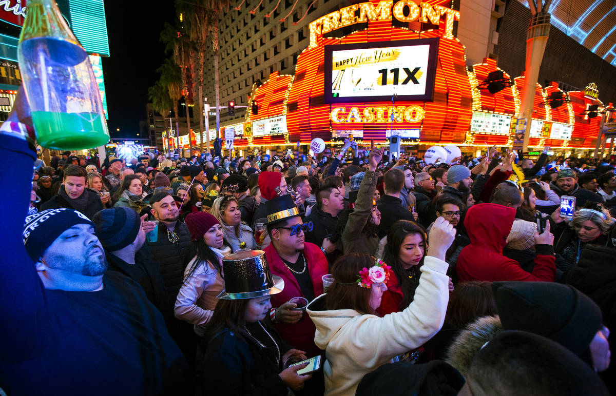 New Year's Eve revelers gather at a stage at the Fremont Street Experience in downtown Las Vega ...