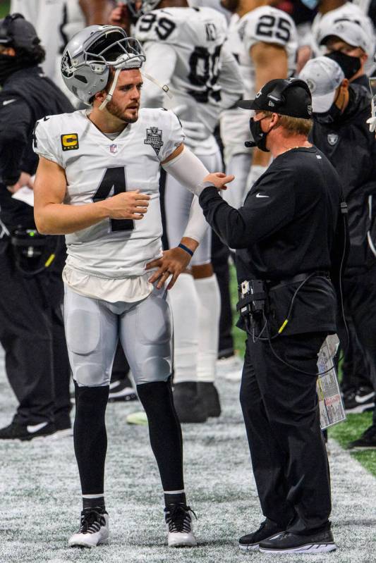 Las Vegas Raiders head coach Jon Gruden talks with quarterback Derek Carr (4) during the first ...