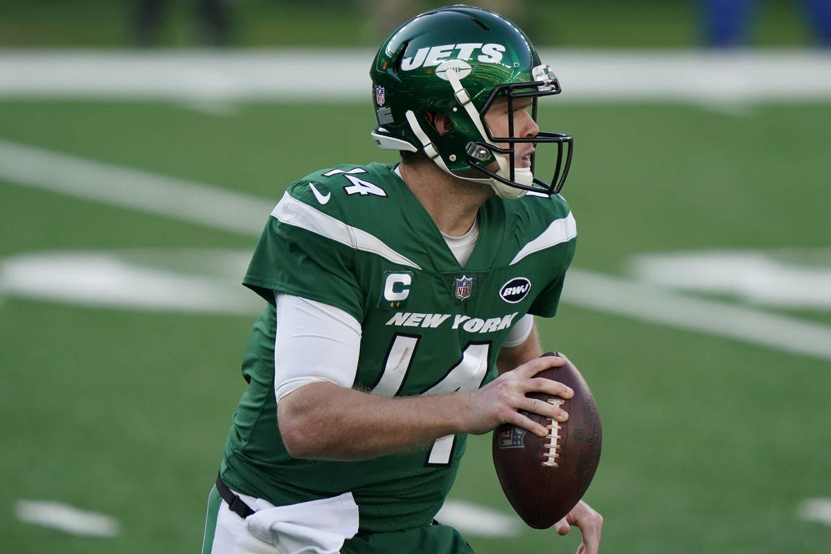 New York Jets quarterback Sam Darnold looks to throw during the first half of an NFL football g ...