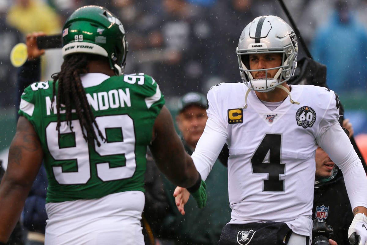 Oakland Raiders quarterback Derek Carr (4) greets New York Jets nose tackle Steve McLendon (99) ...