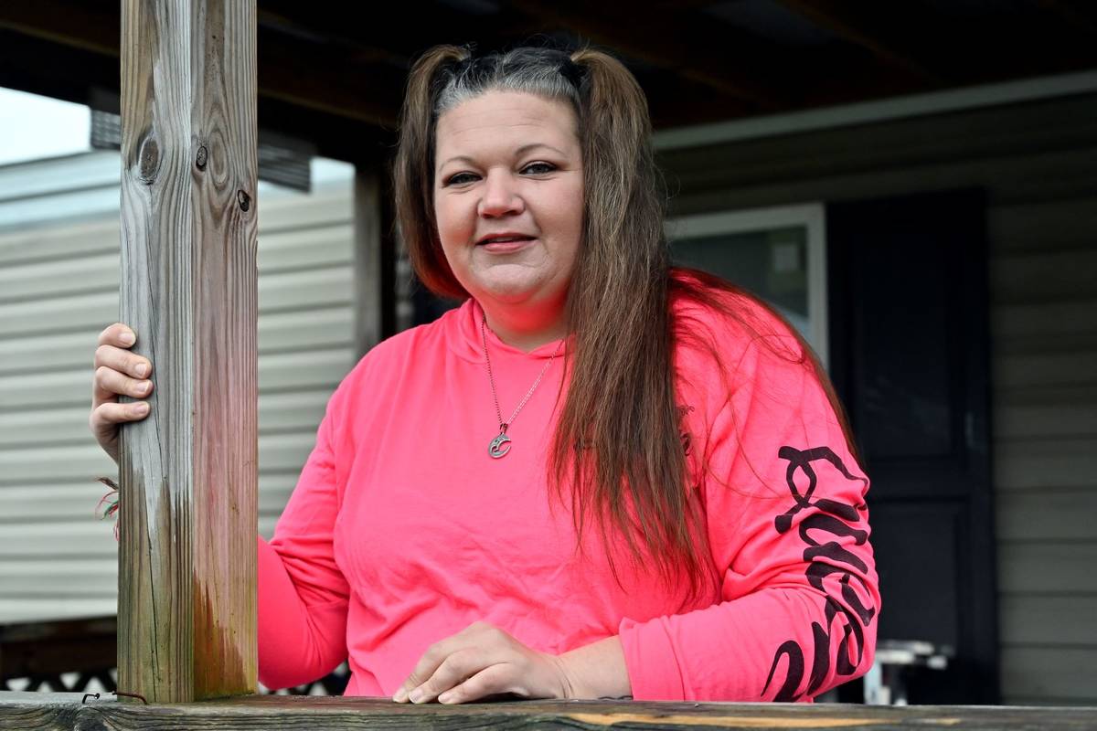 Tina Morton stands on the porch of her home in Winchester, Ky., Friday, Dec. 4, 2020. (AP Photo ...