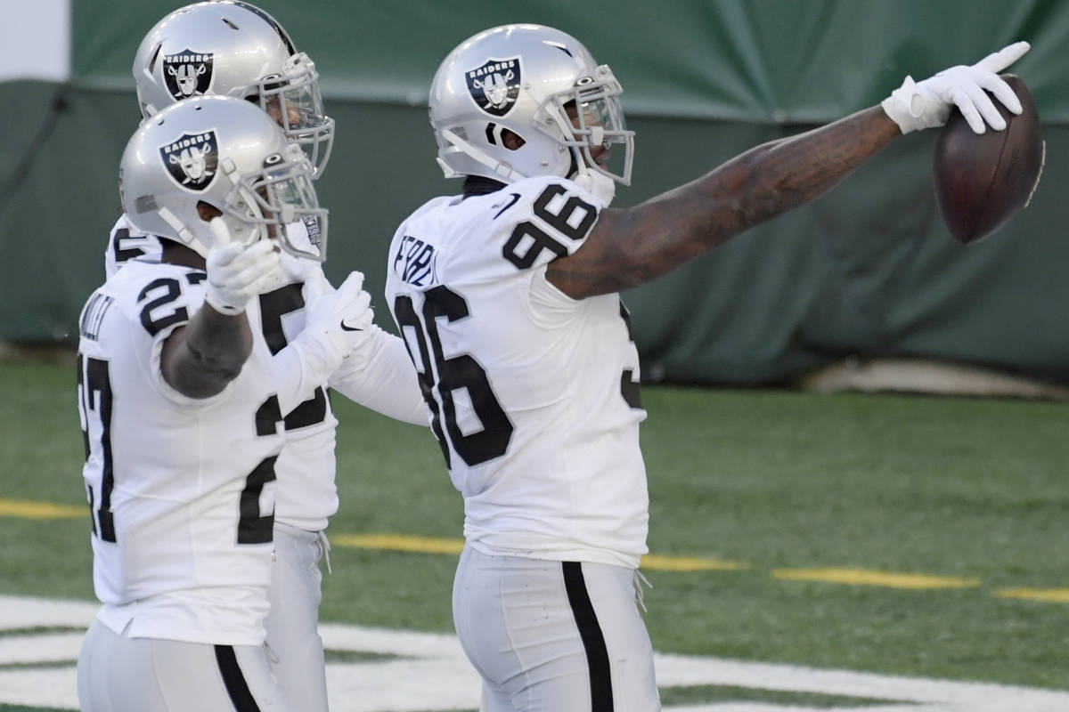 Las Vegas Raiders' Clelin Ferrell, right, celebrates a turnover with teammates during the first ...