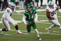 New York Jets quarterback Sam Darnold, center, scrambles during a two-point conversion attempt ...