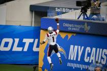 New England Patriots quarterback Cam Newton (1) celebrates after scoring against the Los Angele ...