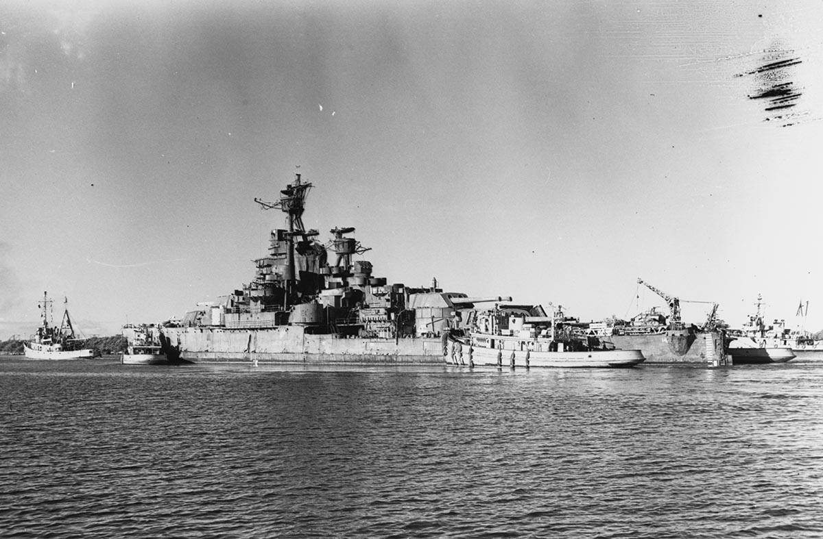 The USS Nevada’s departure from Pearl Harbor under tow by the USS Jicarilla on July 26, 1948. ...