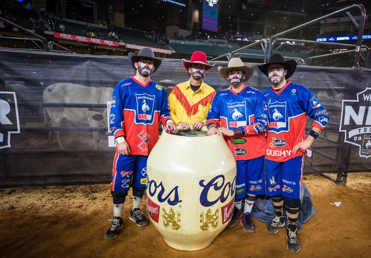 Clowns are seen during the 4th go-round of the National Finals Rodeo in Arlington, Texas, on Su ...