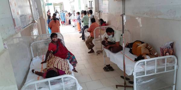 Patients and their bystanders are seen at the district government hospital in Eluru, Andhra Pra ...