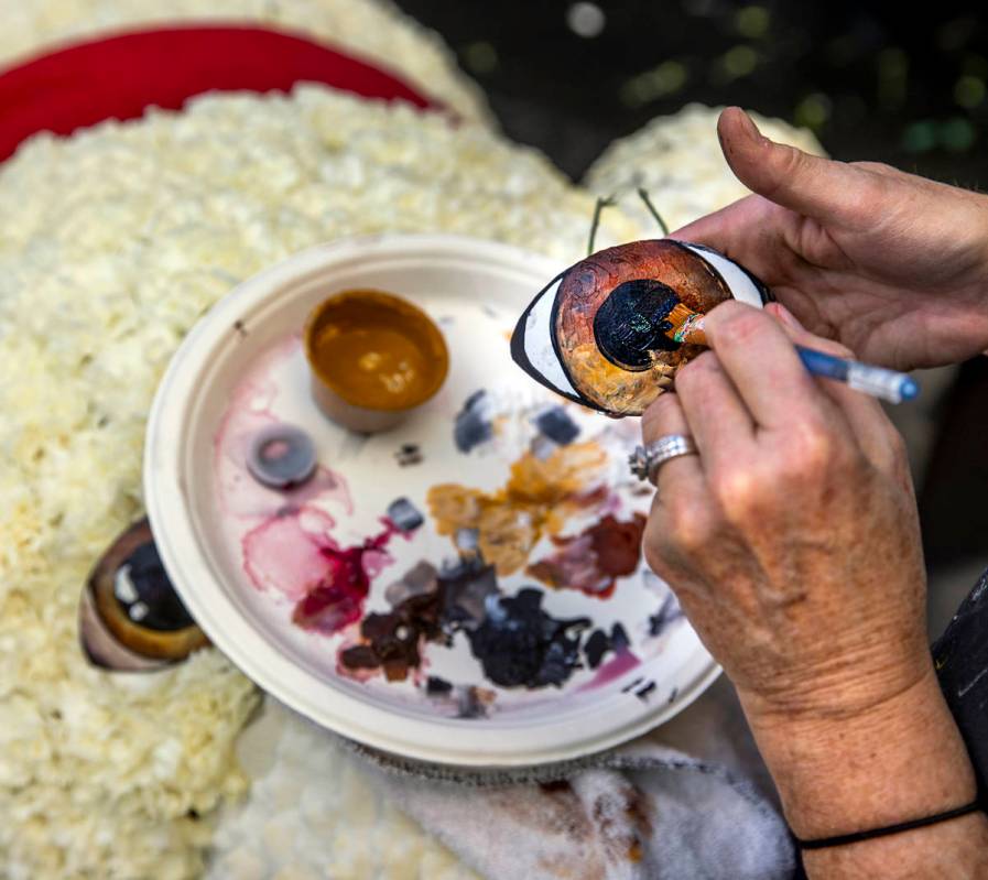 Artist Natalie Tremayne touches up the eye of a Coca-Cola polar bear about the new winter displ ...