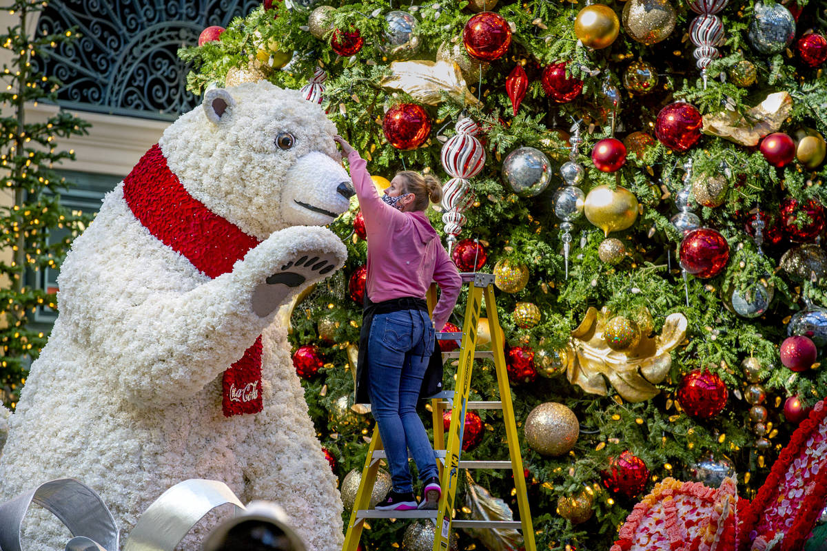 Artist Natalie Tremayne touches up the eye of a Coca-Cola polar bear about the new winter displ ...