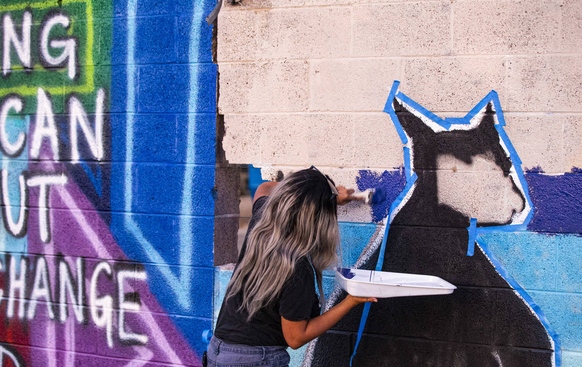 Kayla Bunting, of Henderson, work on a mural at the site of the former Moulin Rouge in Las Vega ...