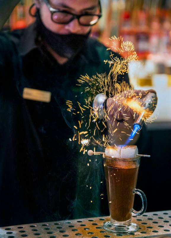 Bartender Anthony Wu prepares a Campfire Hot Chocolate at Vegas Vickie's Cocktail Lounge at Cir ...